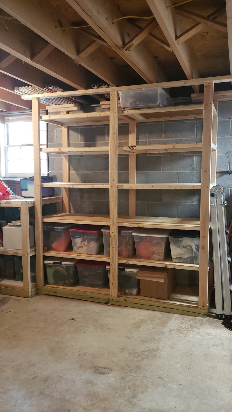 Basement storage shelf made from wood against wall