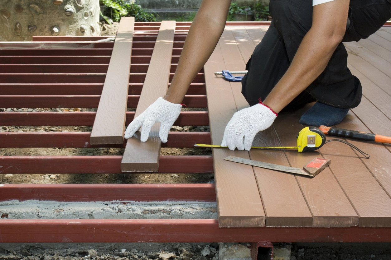 A close up photo of deck boards being lined up
