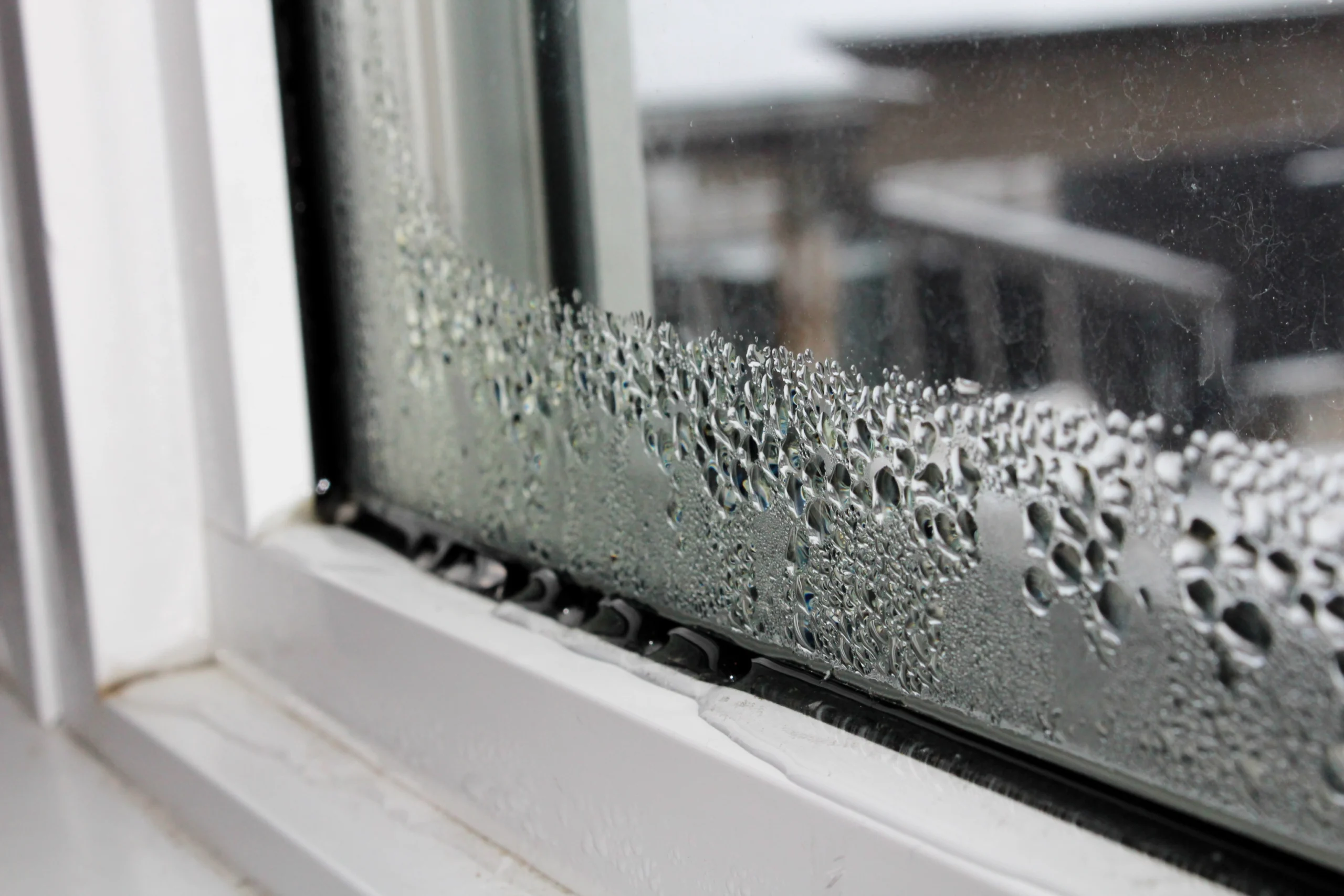 A photo of a window seal and caulk