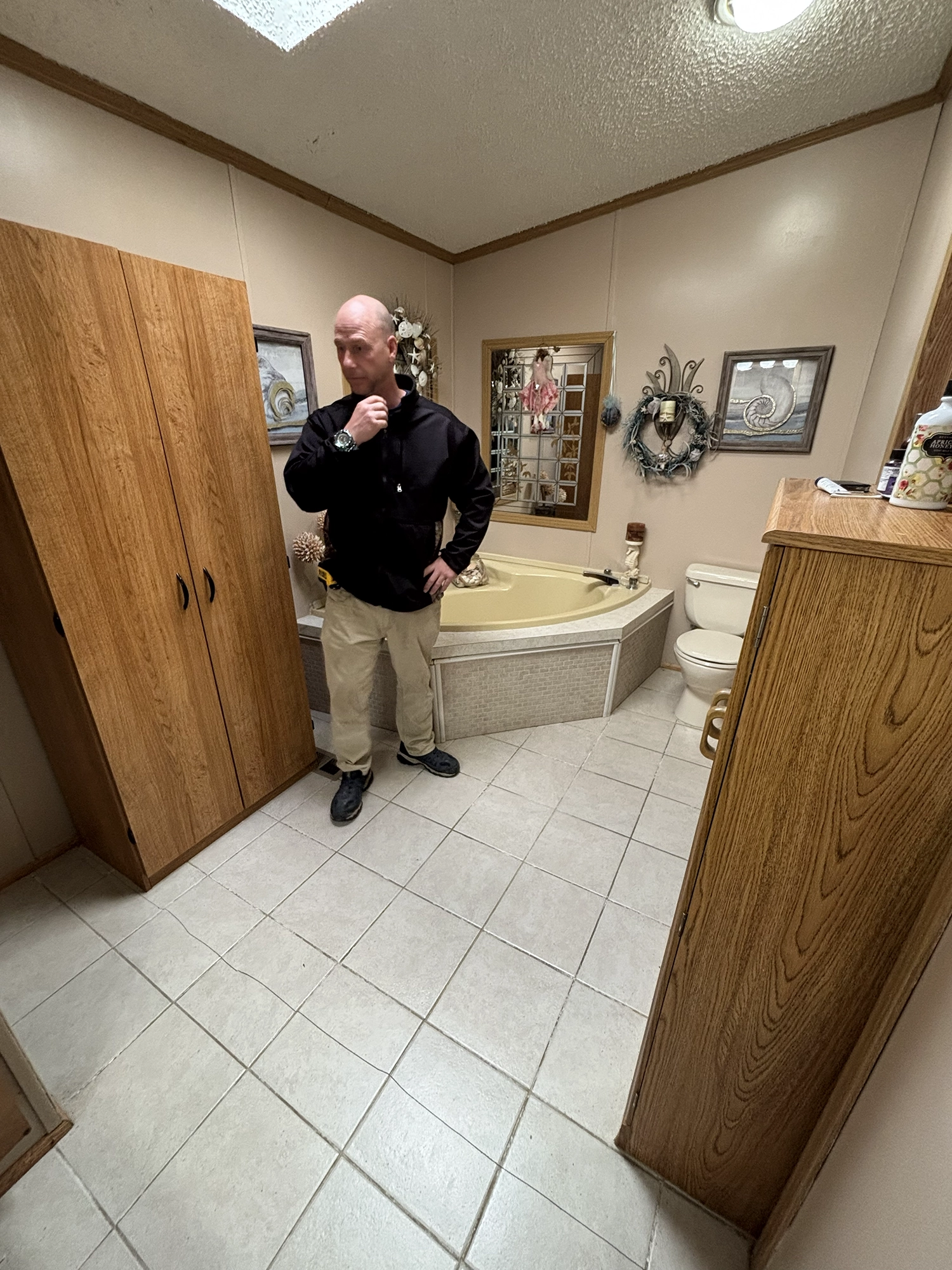 A photo of a HMC worker evaulating a bathroom
