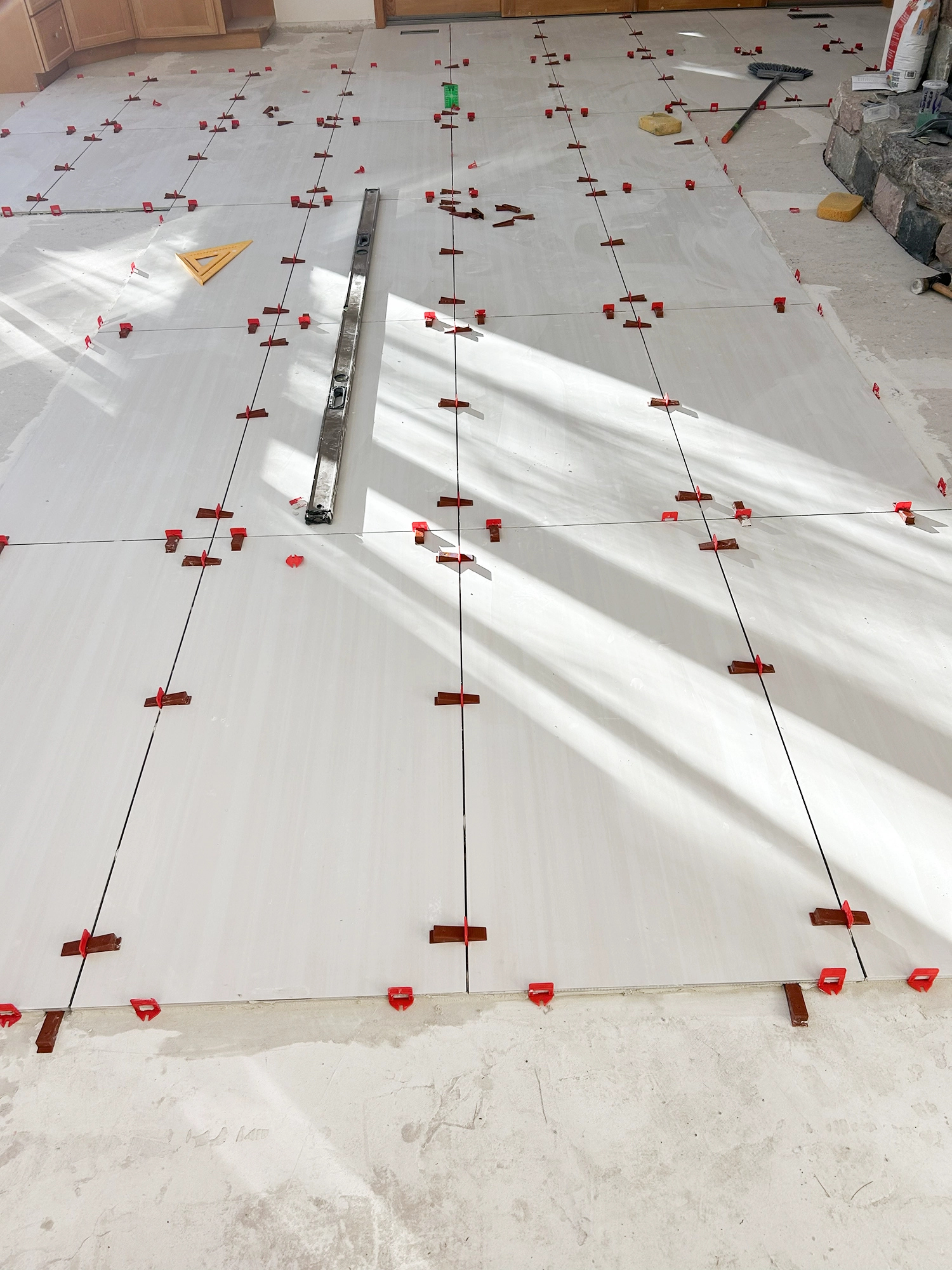 A photo of a HMC worker installing new flooring is a customers living room