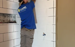 Working on shower remodel - worker small | Handyman Connection of Lake Orion A HMC worker working on shower remodel