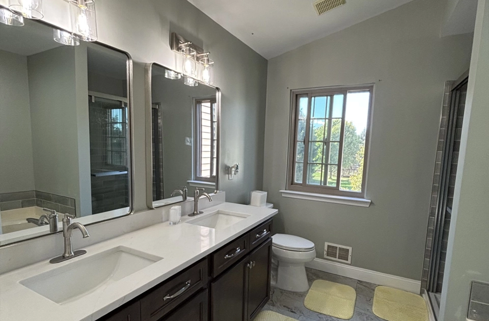 A completely remodeled bathroom using a modern style.