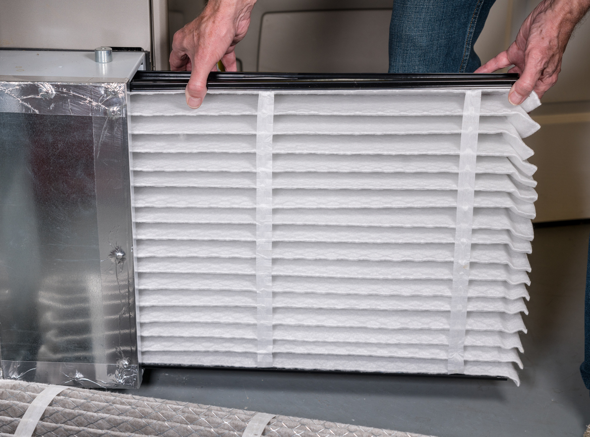 a photo of a filter being inserted into position of a furnace