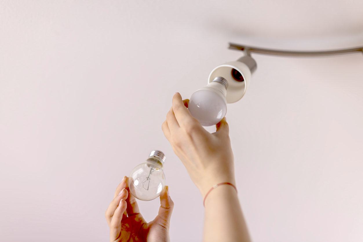 A photo of a light bulb being replaced
